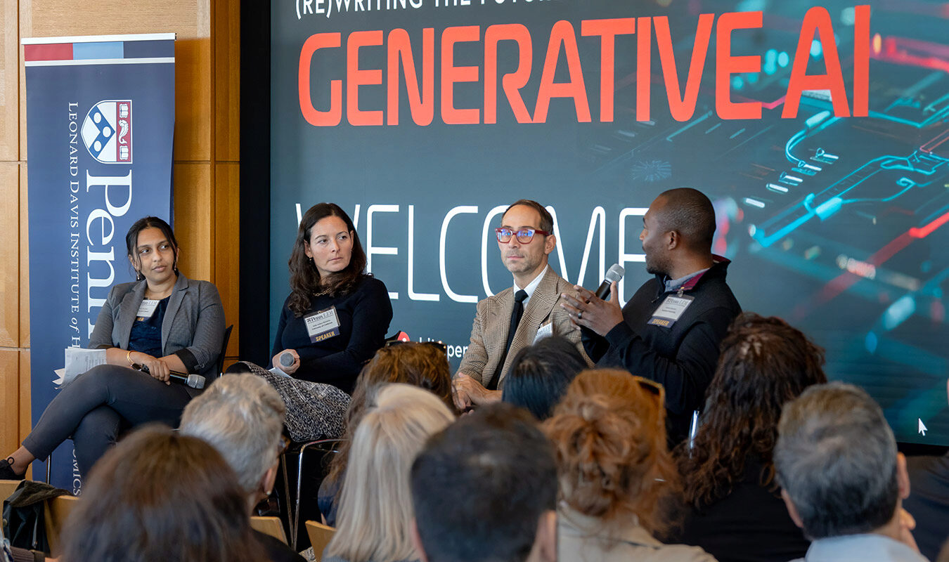 A panel discussion on generative AI, featuring four speakers engaged in conversation. A banner for the Leonard Davis Institute of Health Economics is visible, as well as an audience in the foreground.