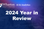 A digital banner featuring text "Wharton AI & Analytics, University of Pennsylvania" and "2024 Year in Review" over a blurred cityscape background.