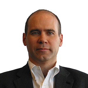 Jim Manzi 300x300 Headshot of a person with short hair, wearing a dark suit jacket and white collared shirt, against a plain background.